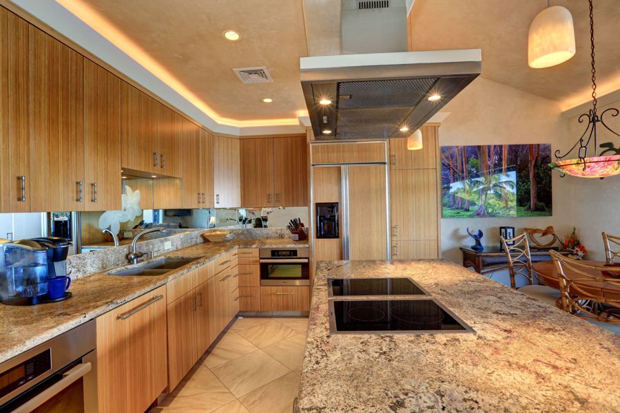 Kitchen with bamboo cabinets, granite and a large island