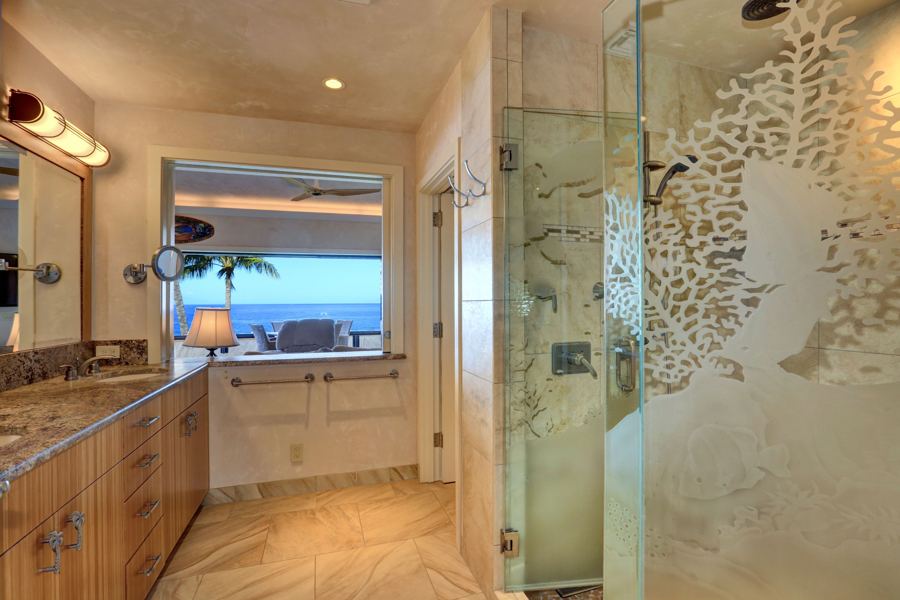Main bathroom with etched glass shower and slider window to the ocean